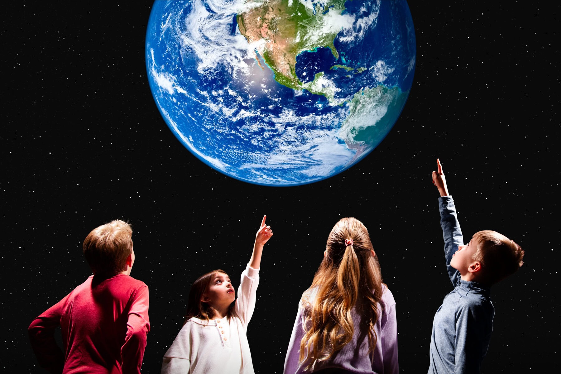 Students point at a giant Earth inside the Starlab